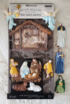 Decorative nativity scene moulds packaging with figures and stable on a white background