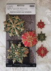 Decorative snowflake moulds on packaging with a white lace background