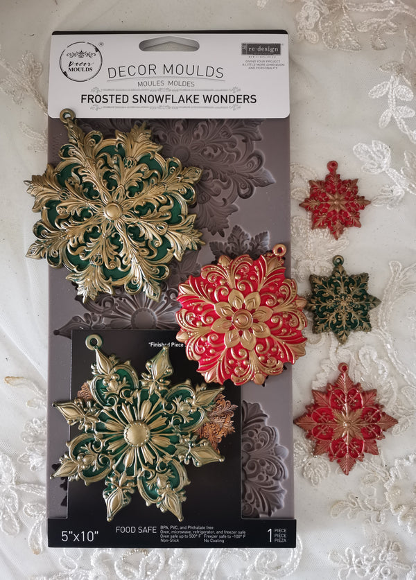 Decorative snowflake moulds on packaging with a white lace background