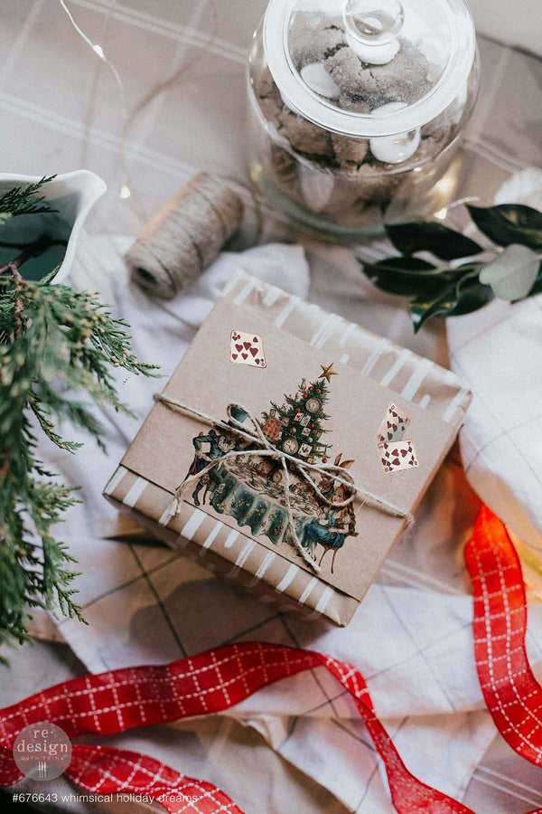 Gift box with Christmas design on a decorative surface with ribbons and plants