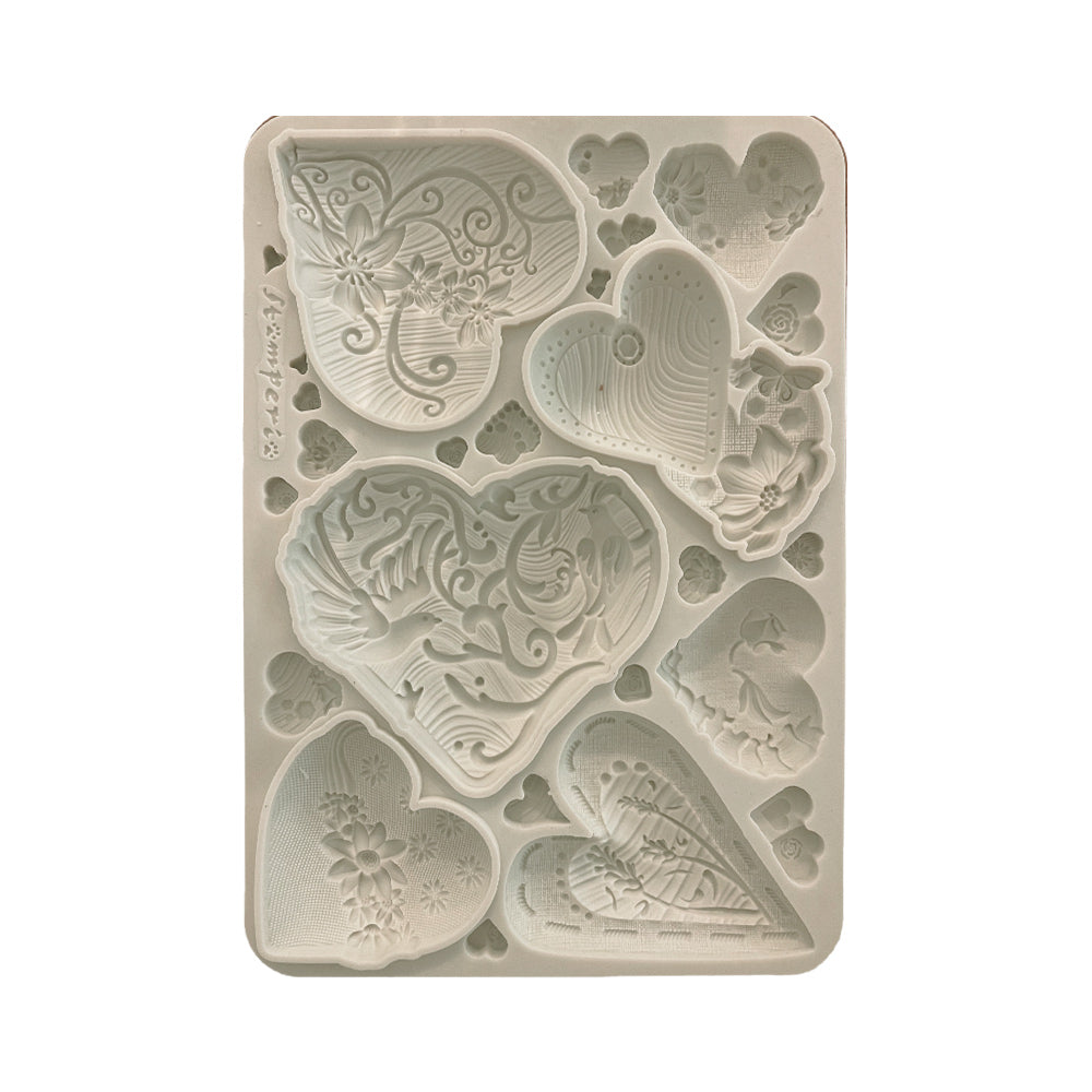 Decorative silicone mold with butterfly and heart designs on a white background