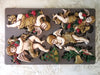 Decorative silicone mold with angel figures and Christmas elements on a gray background