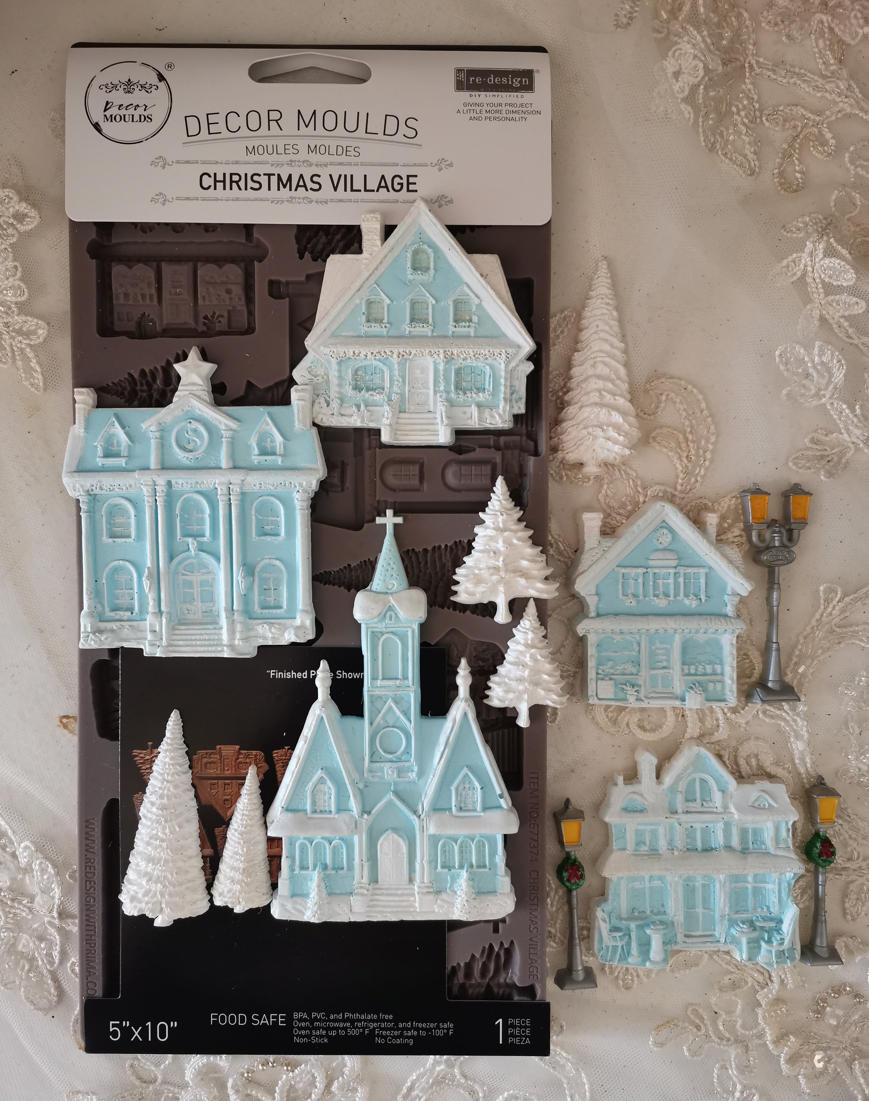 Decorative Christmas village moulds with packaging on a decorative background