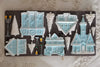 Decorative mold with winter-themed houses and trees on a decorative surface
