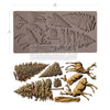 Silicone mold with deer and fern designs and a set of molded items on a white background.