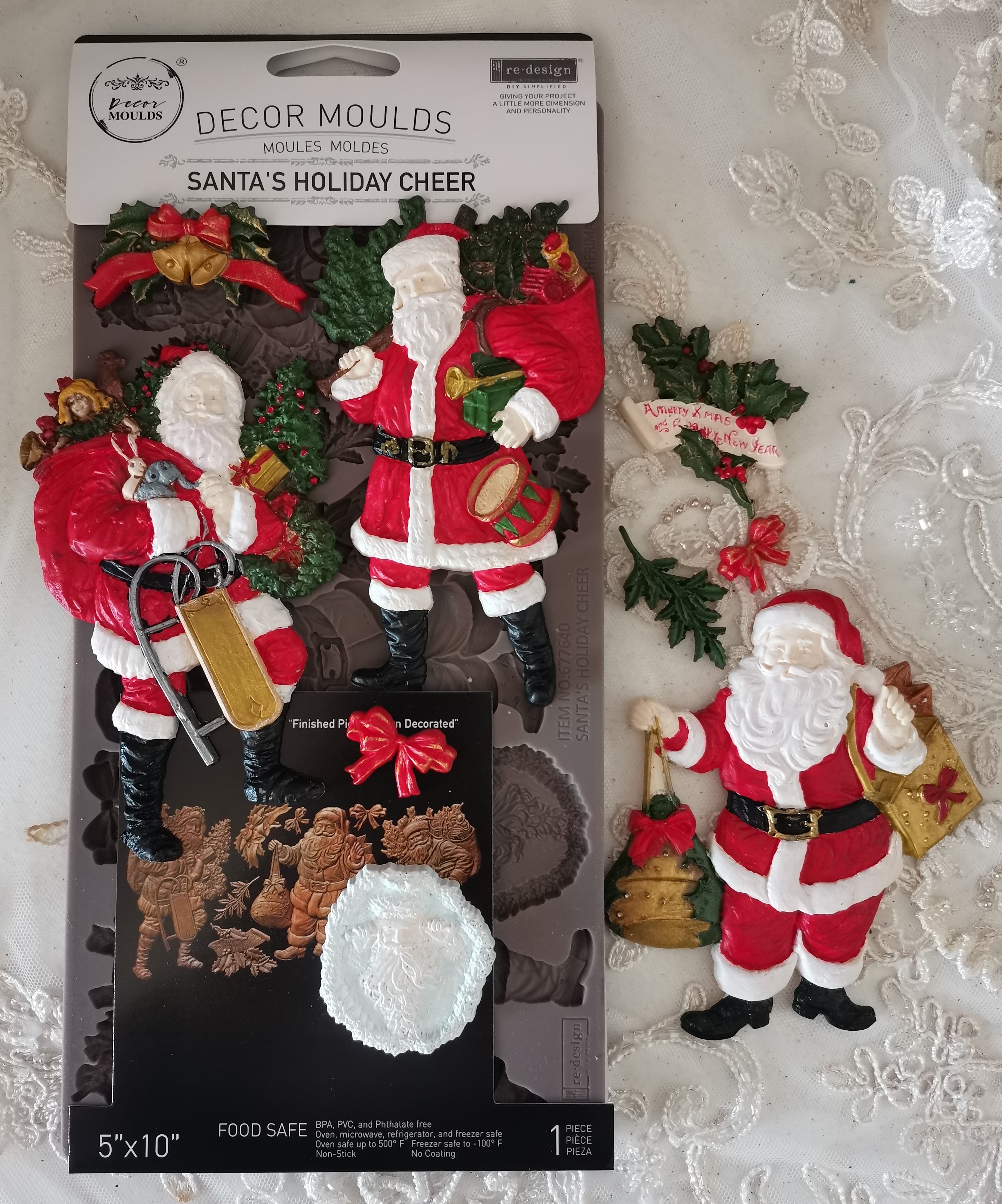 Decorative Santa Claus moulds in packaging with a Christmas-themed background