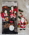Decorative Santa Claus moulds in packaging with a Christmas-themed background