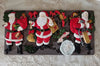 Set of Santa Claus-themed chocolate molds on a decorative surface