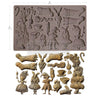 Silicone mold with Alice in Wonderland-themed cavities and the actual molded items on a white background.