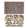Decorative silicone mold with floral and bow designs on a white background