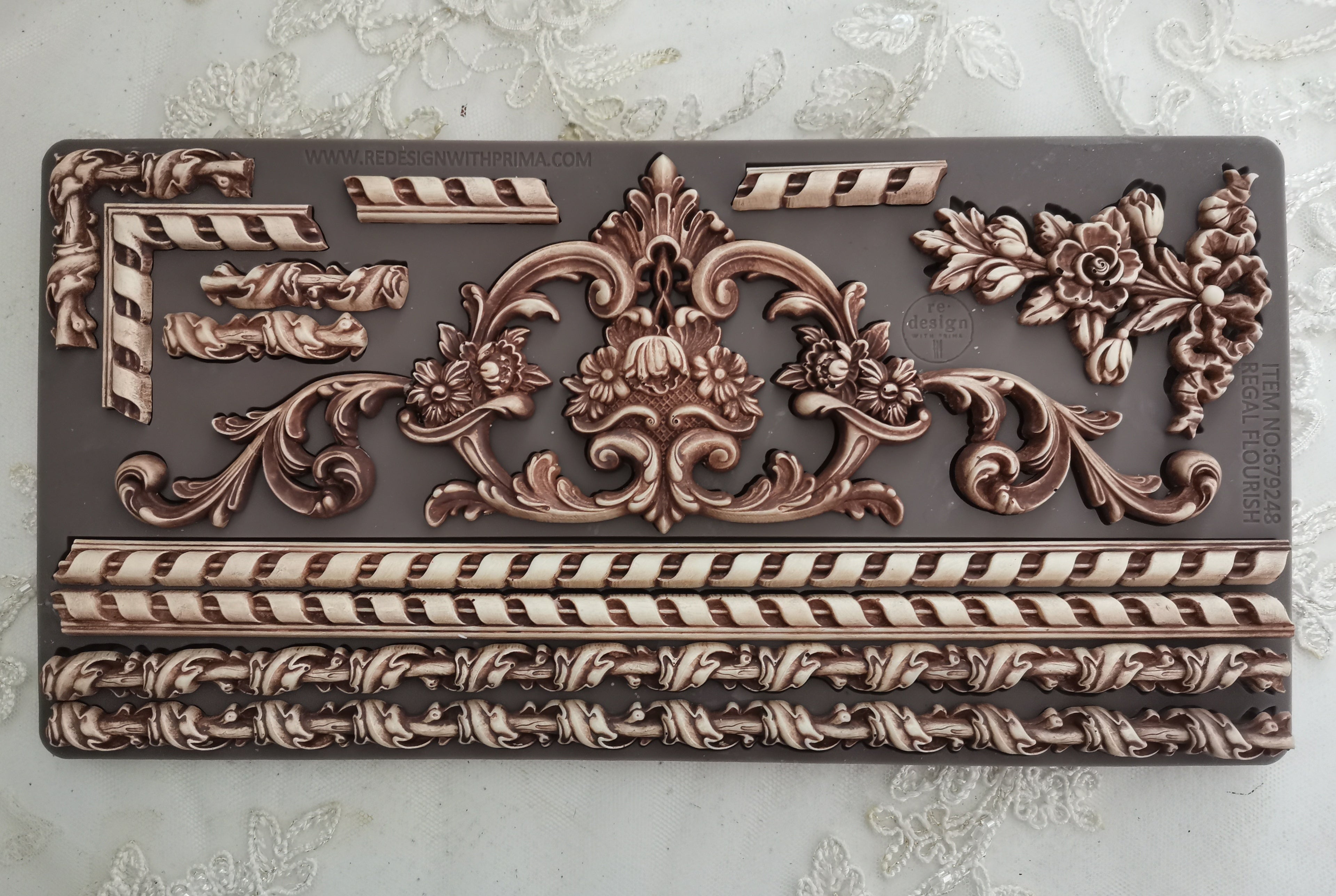 Decorative metal panel with intricate patterns on a textured background