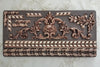 Decorative metal panel with intricate patterns on a textured background