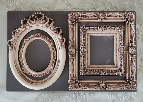 Two ornate picture frames on a textured surface
