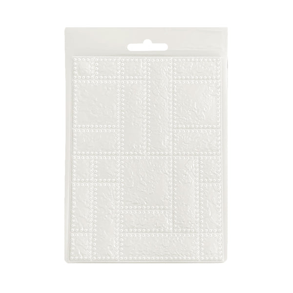 Clear plastic impression mould on a white background