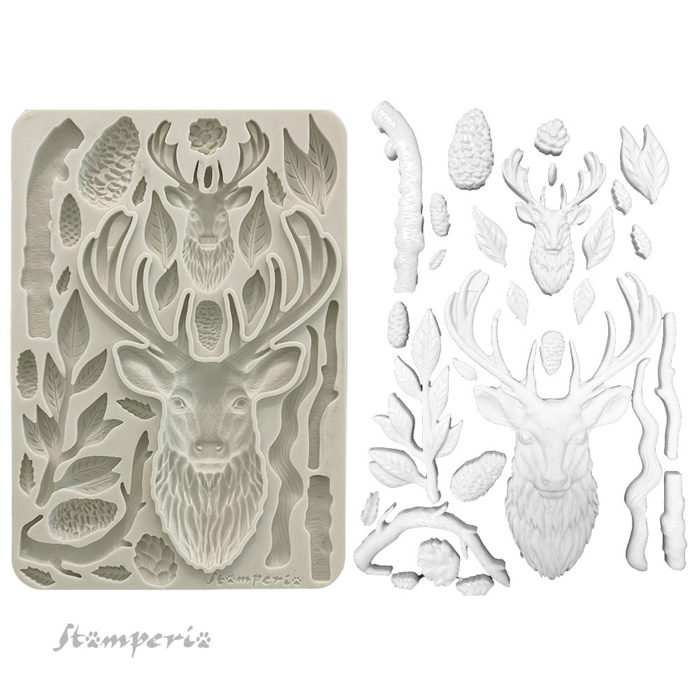 Deer head mould and castings with foliage on a white background