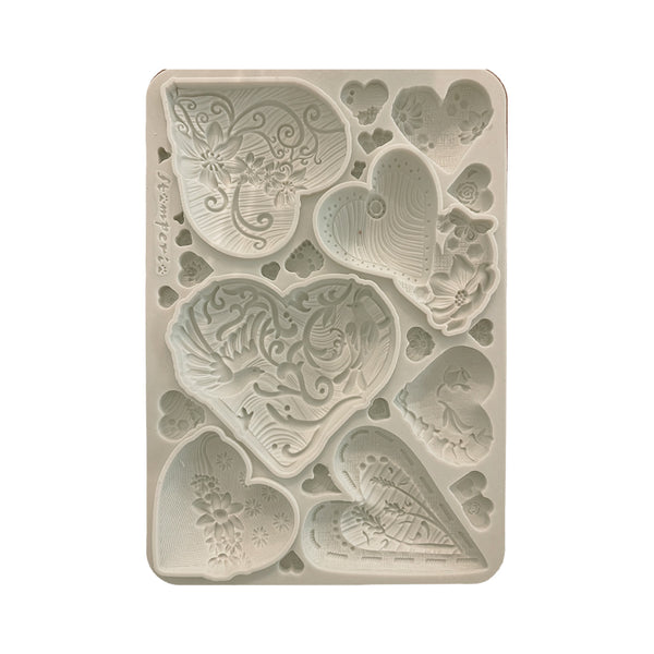 Decorative silicone mold with butterfly and heart designs on a white background
