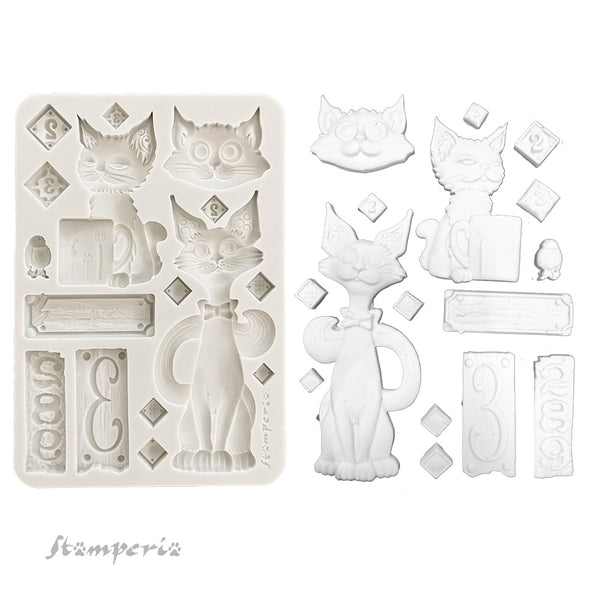 Silicone mold with cat-shaped cavities and decorative elements on a white background