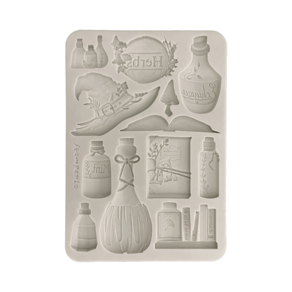 Silicone mold with various bottle and book designs on a white background