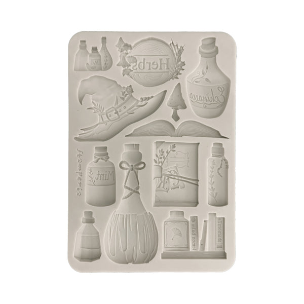 Silicone mold with various bottle and book designs on a white background
