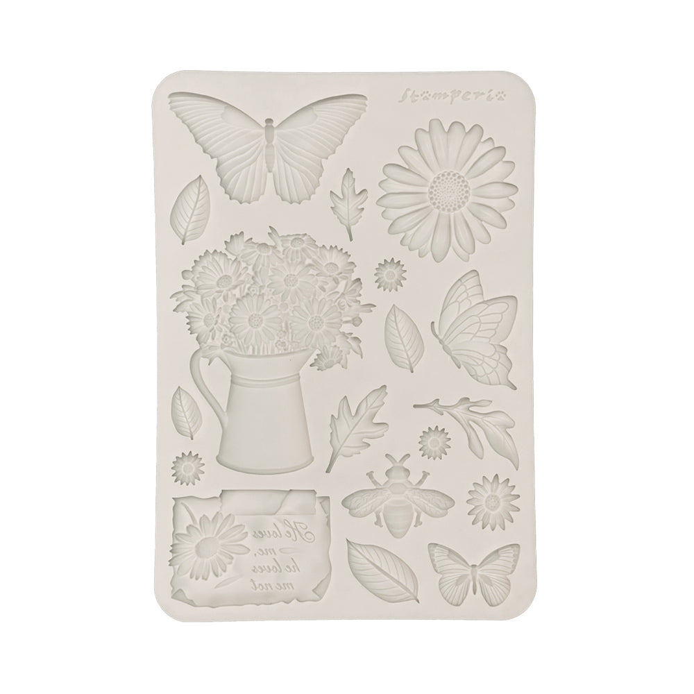 Decorative silicone mold with floral and butterfly designs on a white background