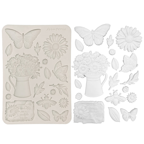 Decorative silicone mold with floral and butterfly designs on a white background