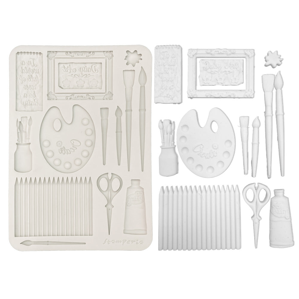 Set of white art supplies including brushes, scissors, and frames on a white background