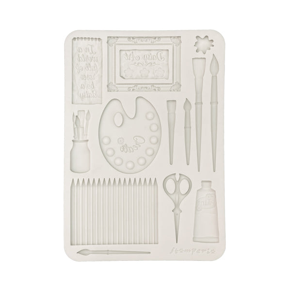Decorative mold with artistic tools on a white background
