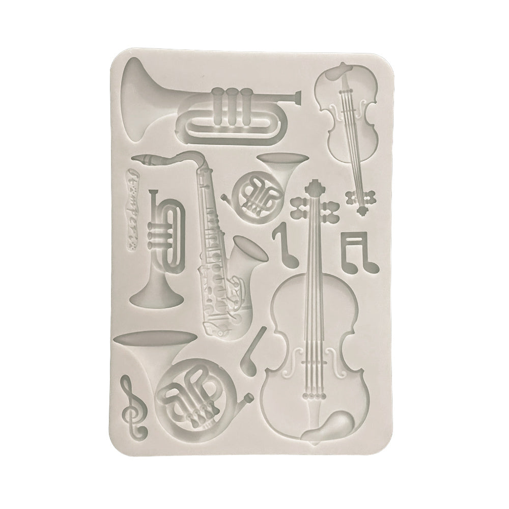 Silicone mold with musical instrument shapes on a white background