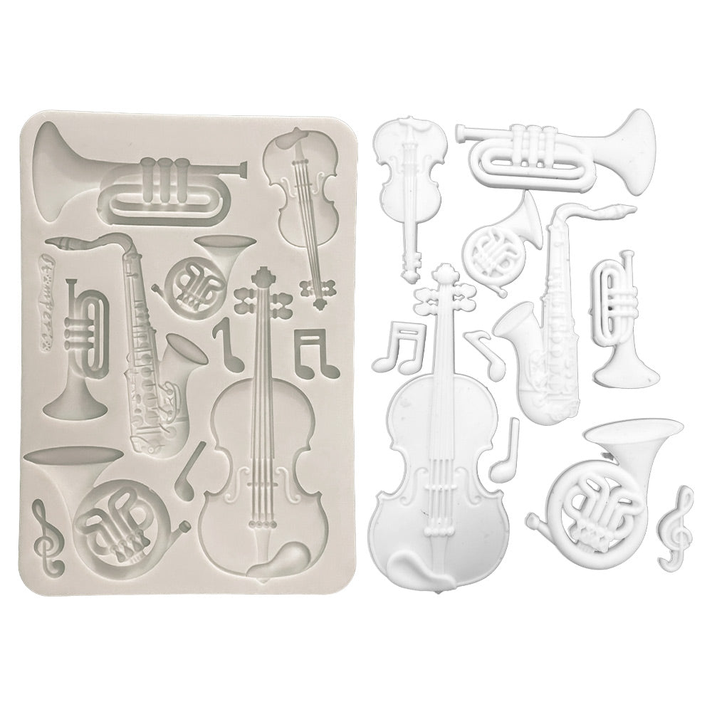 Silicone mold with musical instrument shapes on a white background