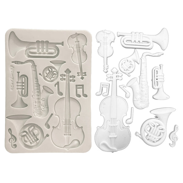 Silicone mold with musical instrument shapes on a white background