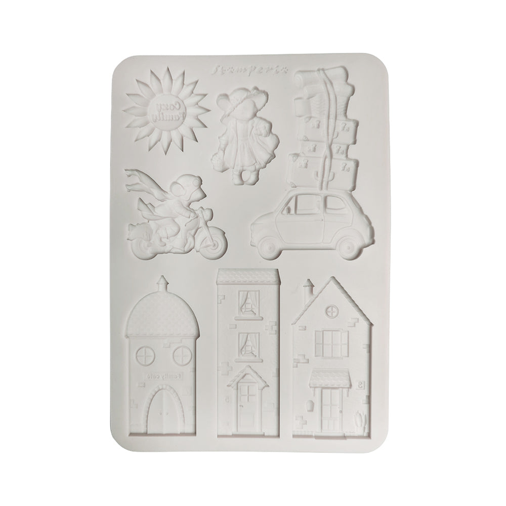 A white rectangular silicone mold with six embossed cartoon-style shapes, including a sun, a child, a scooter, a car, stacked boxes, and three house designs, shown on a plain white background.