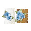 Two decorative paper pieces with blue flowers and green leaves on a white background