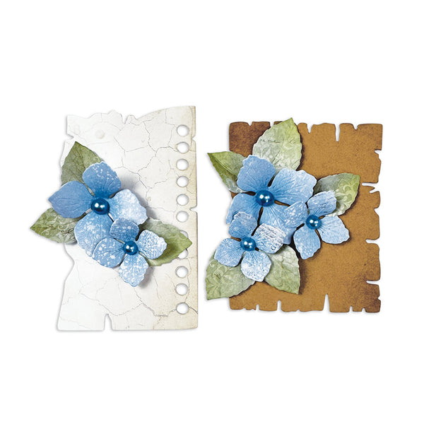 Two decorative paper pieces with blue flowers and green leaves on a white background