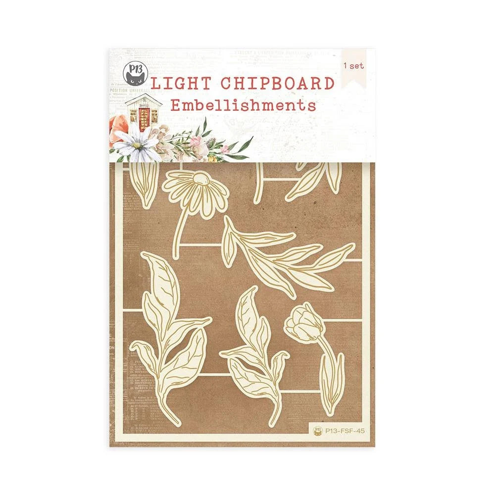 Packaging of light chipboard embellishments with floral designs on a brown background