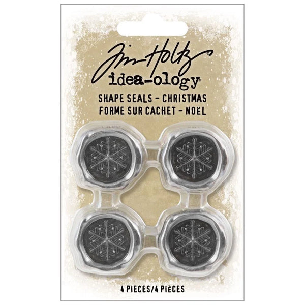 Pack of Tim Holtz Shape Seals with snowflake designs on a beige background