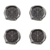 Four metallic seals with snowflake designs on a white background