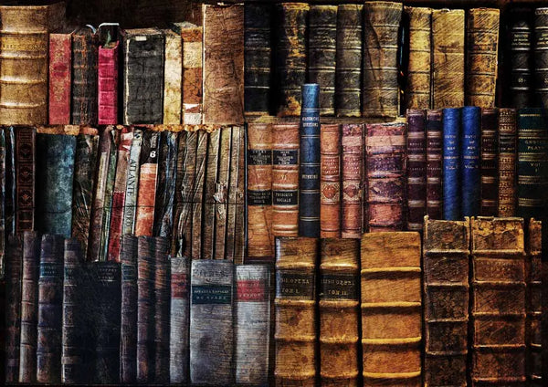 Stacks of old, worn books with visible titles against a dark background
